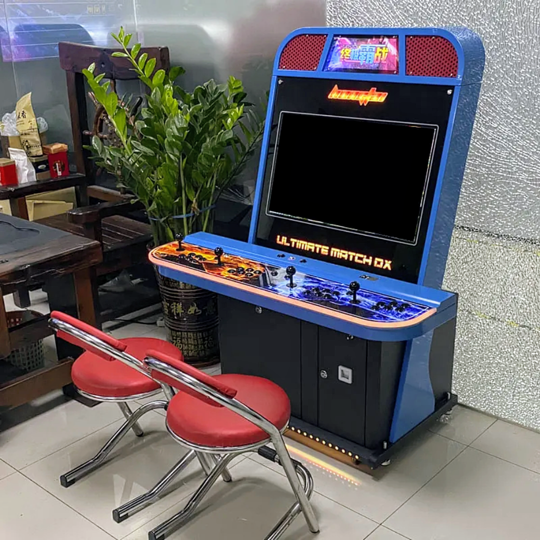 4 player arcade cabinet with a blue and black design, the control panel has a beautiful orange and black art design, the arcade also features 4 black joysticks and buttons. It also has an optional coin slot. 2 chairs are in front of the cabinet the chairs are red, there's a green plant right behind the arcade.