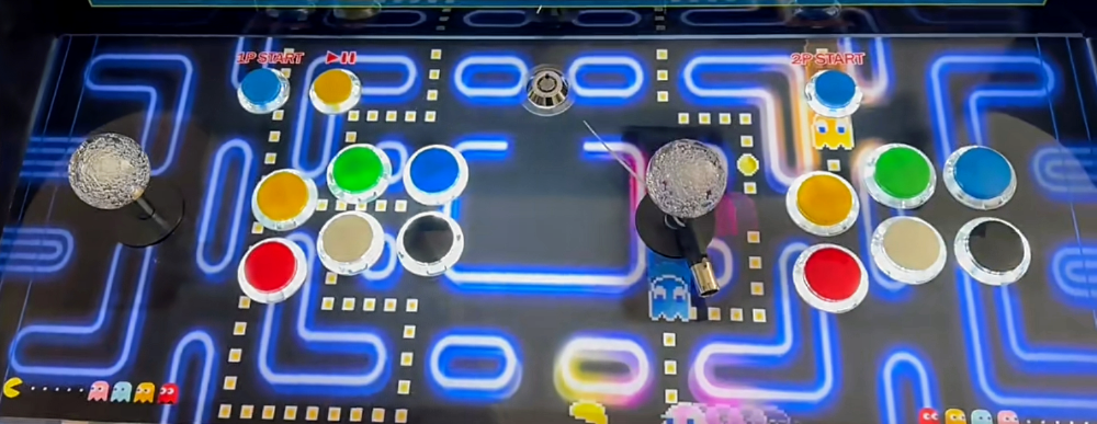 Close up picture of 2 Player Tabletop Arcade Cabinet that features different button colors like blue, black, yellow, orange, and yellow. The 2 joysticks are clear joysticks. 